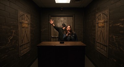 A person in an escape room standing behind the counter.