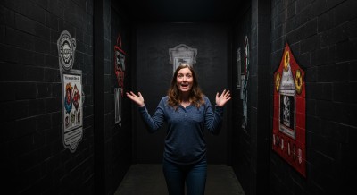 Escape room participant raising arms in excitement