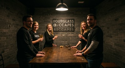 Group of friends standing around the table in an escape room.